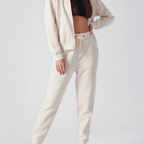A woman standing in high quality womens white zip up hoodies for a clean look.