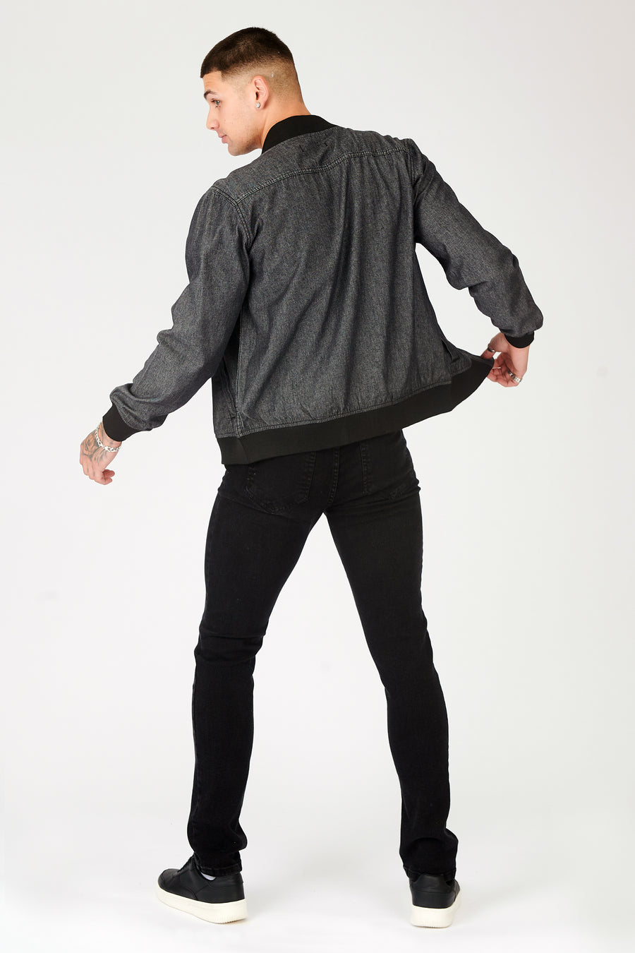 Full body back shot of a standing male model wearing a JMOJO Grey Bomber Jacket