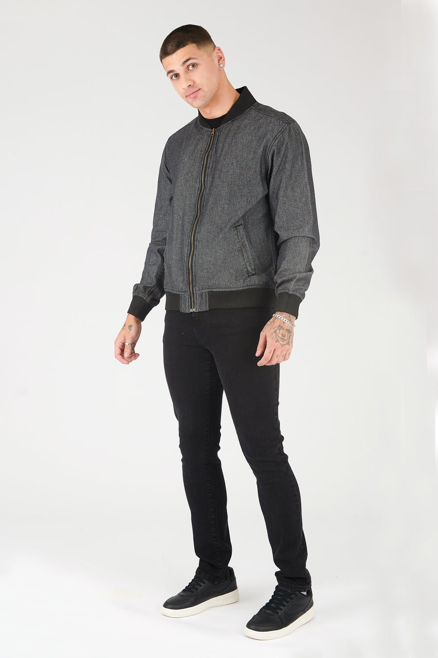 Full body shot of a standing male model wearing a zipped up JMOJO Grey Bomber Jacket