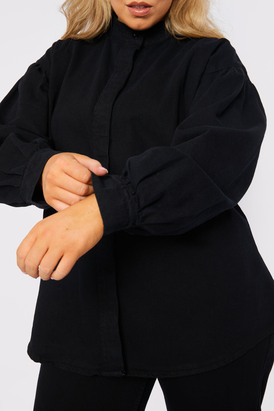 Body shot of a standing plus size female model wearing JMOJO Black Balloon Sleeve Denim Shirt
