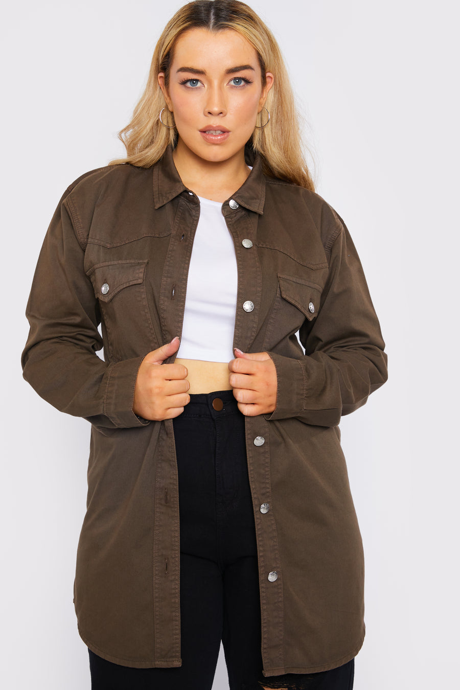 Body shot of a standing plus size female model wearing a JMOJO Brown Wash Long Sleeve Denim Shirt