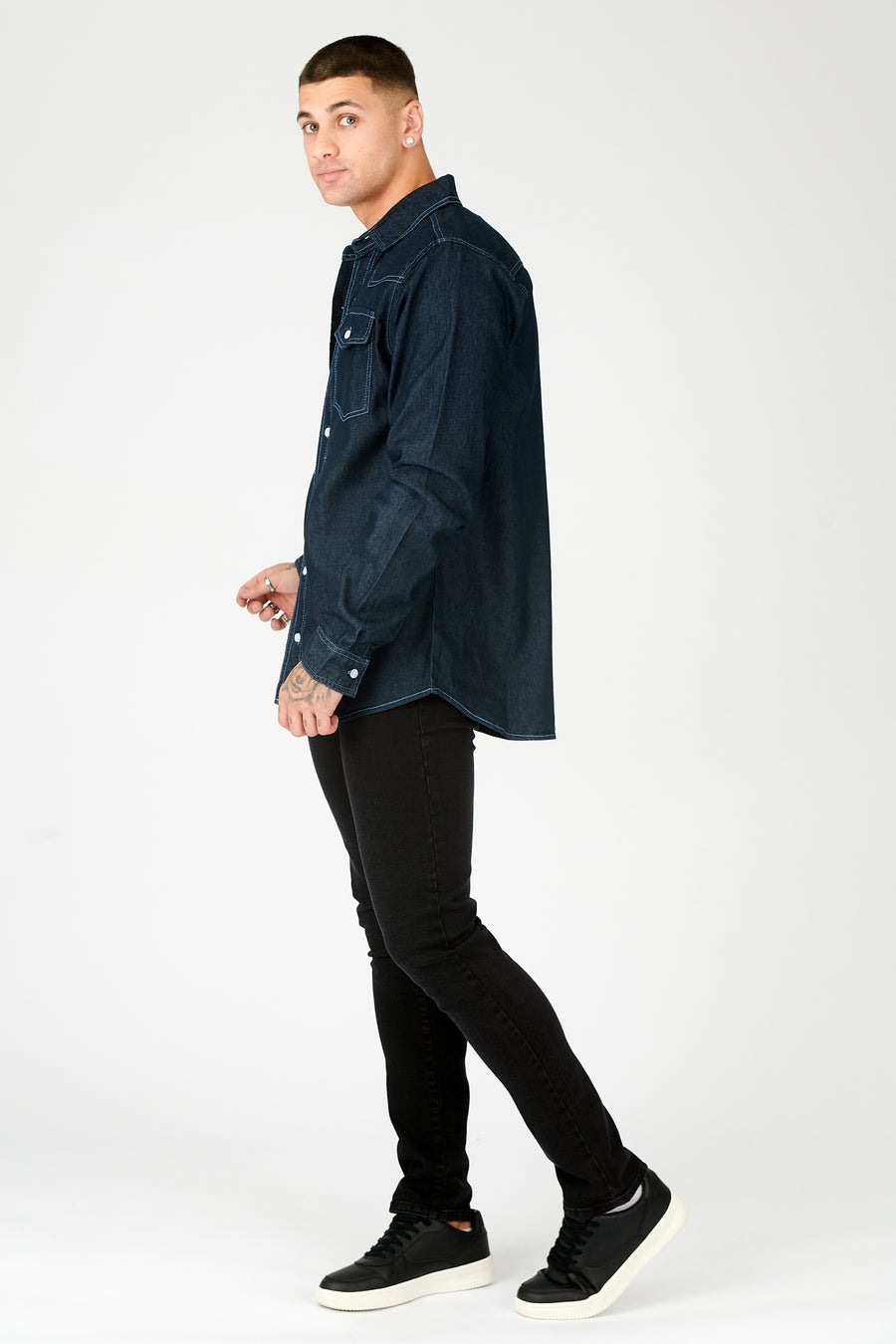 Full body shot of a standing male model wearing a JMOJO Dark Indigo Blue Slim Fit Contrast Stitch Denim Shirt