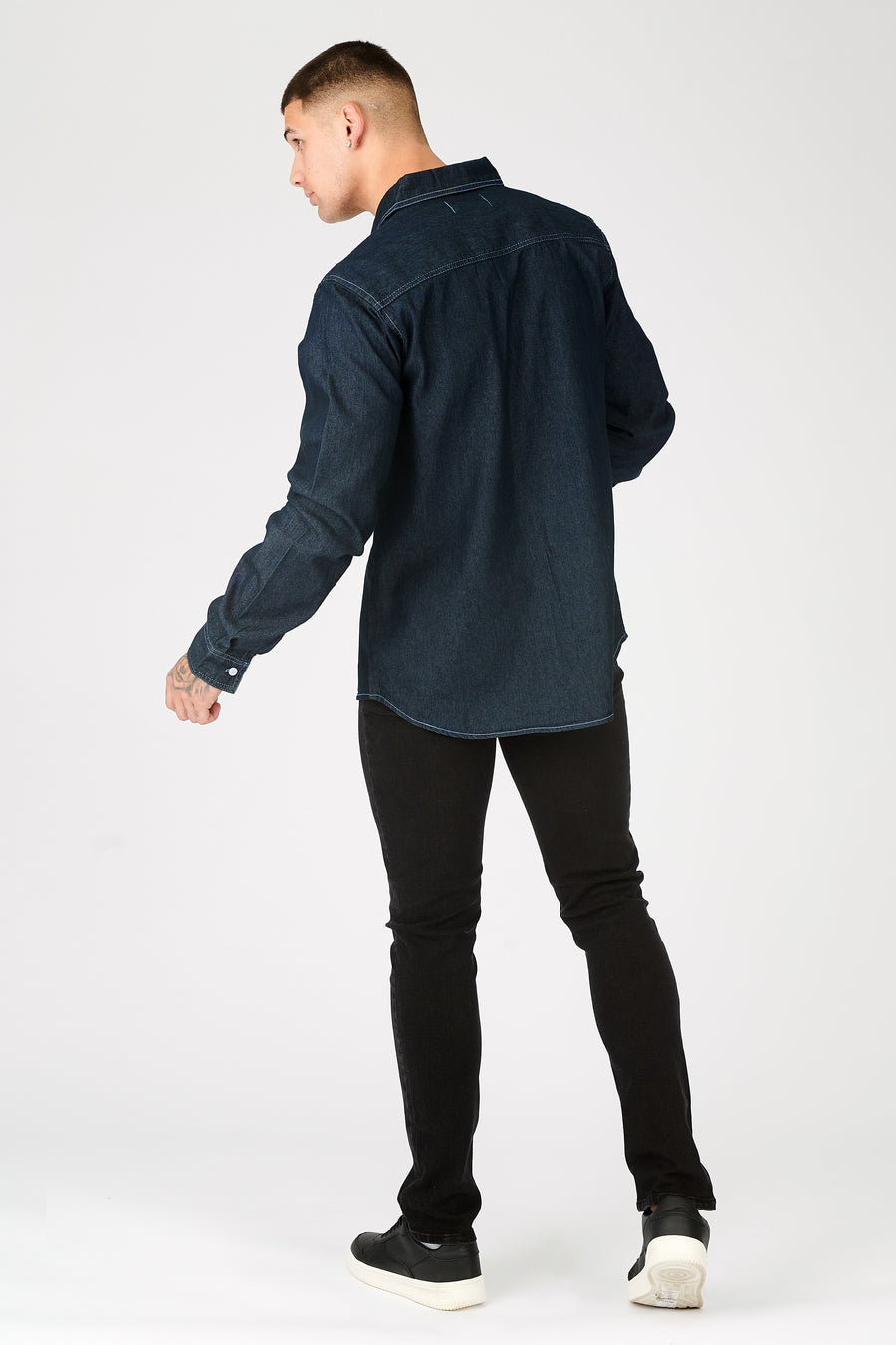 Full body shot of a standing male model wearing a JMOJO Dark Indigo Blue Slim Fit Contrast Stitch Denim Shirt
