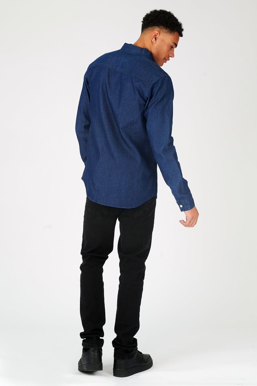 Body back shot of a standing male model wearing a JMOJO Indigo Blue Slim Fit Grandad Collar Denim Shirt