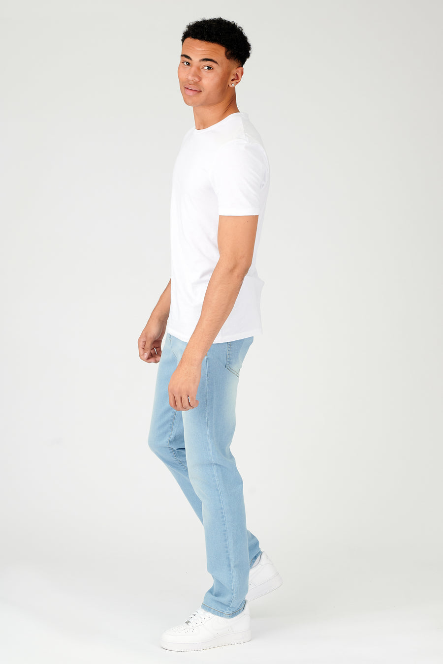 Full body shot of a standing male model wearing JMOJO Grey Wash Slim Fit Jeans