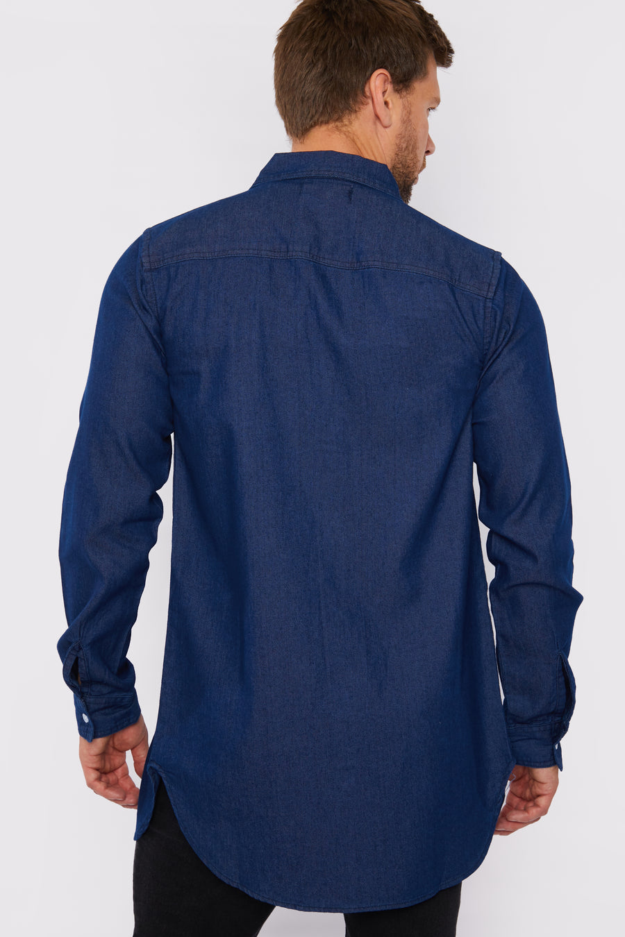 Body back shot of a standing male model wearing a JMOJO Dark Blue Slim Fit Longline Denim Shirt