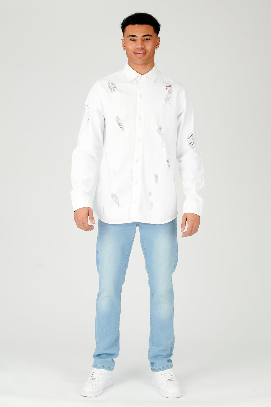 Body shot of a standing male model wearing a JMOJO White Slim Fit Ripped Denim Shirt