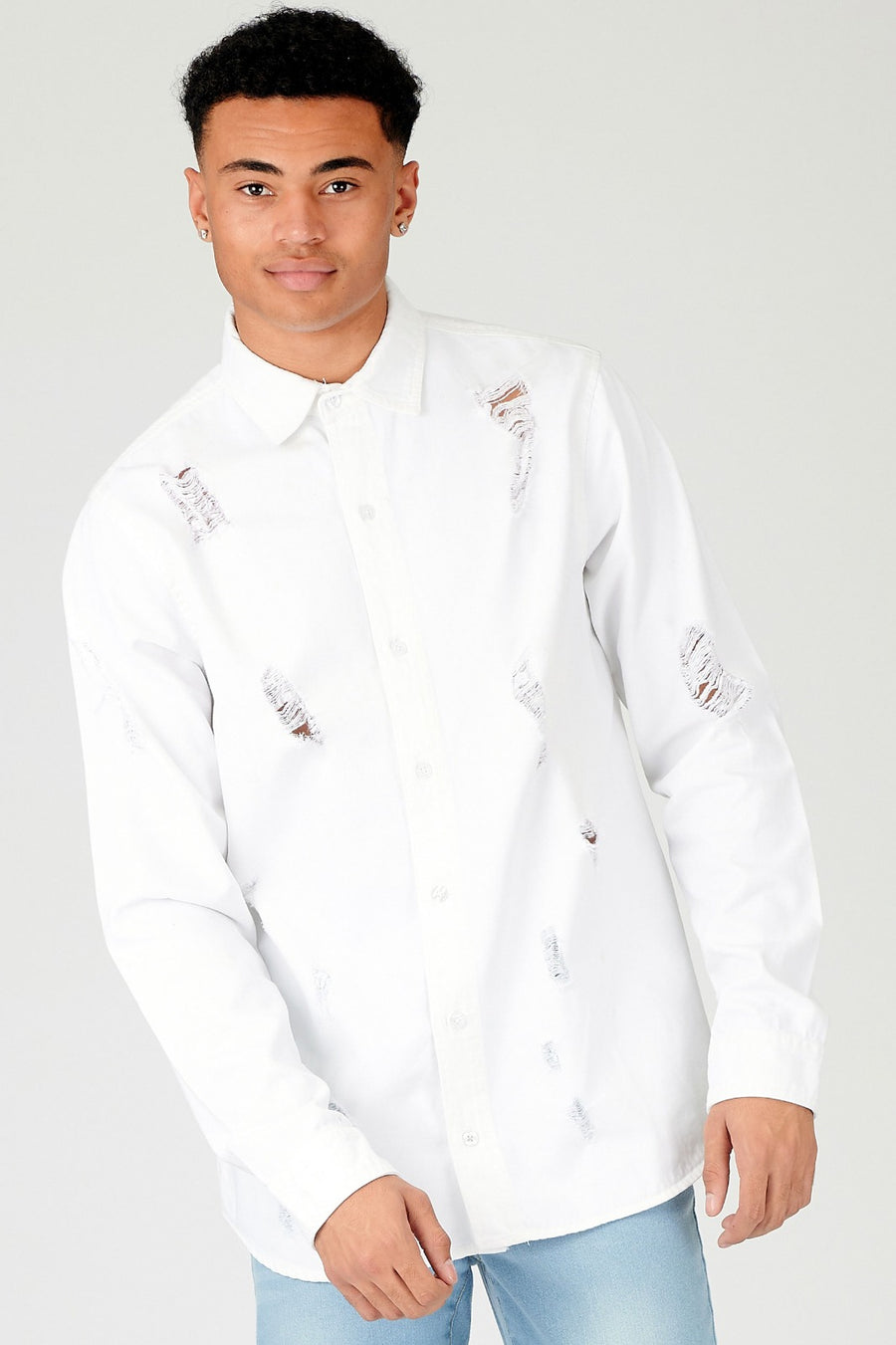 Close body shot of a standing male model wearing a JMOJO White Slim Fit Ripped Denim Shirt