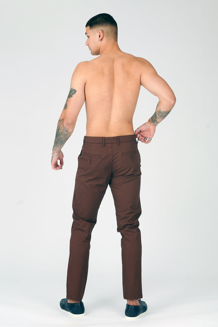 Full body back shot of a standing male model wearing JMOJO Chocolate Brown Slim Fit Stretch Chino Trousers