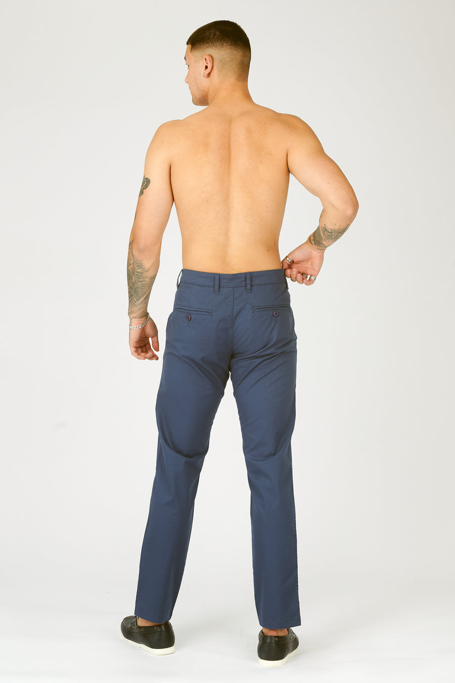 Full body back shot of a standing male model wearing JMOJO Navy Slim Fit Stretch Chino Trousers