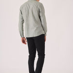 Male model posing in black slim fit chinos trousers.