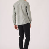 Male model posing in black slim fit chinos trousers.