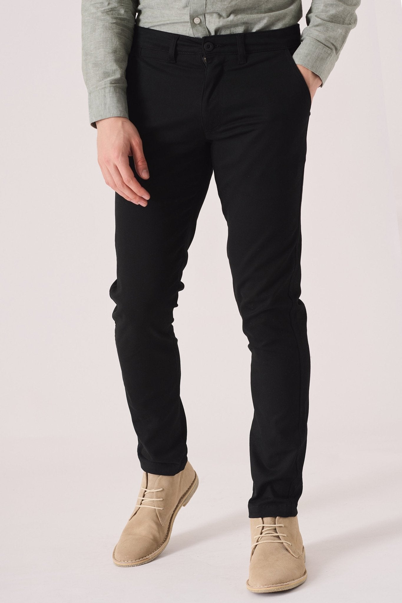 Front shot of black slim fit chinos trousers from the waist down.