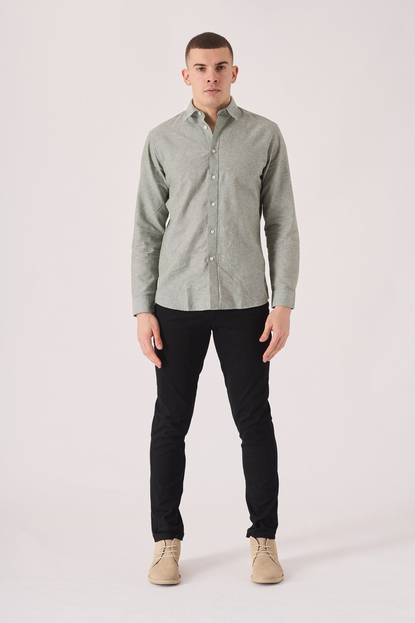 Full front shot of the black slim fit chinos trousers.