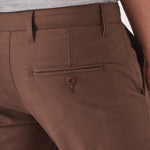 Close up shot of the back pocket on the brown chino trousers.