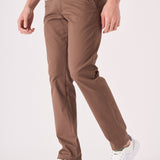Side angle of a man wearing premium brown chino trousers.