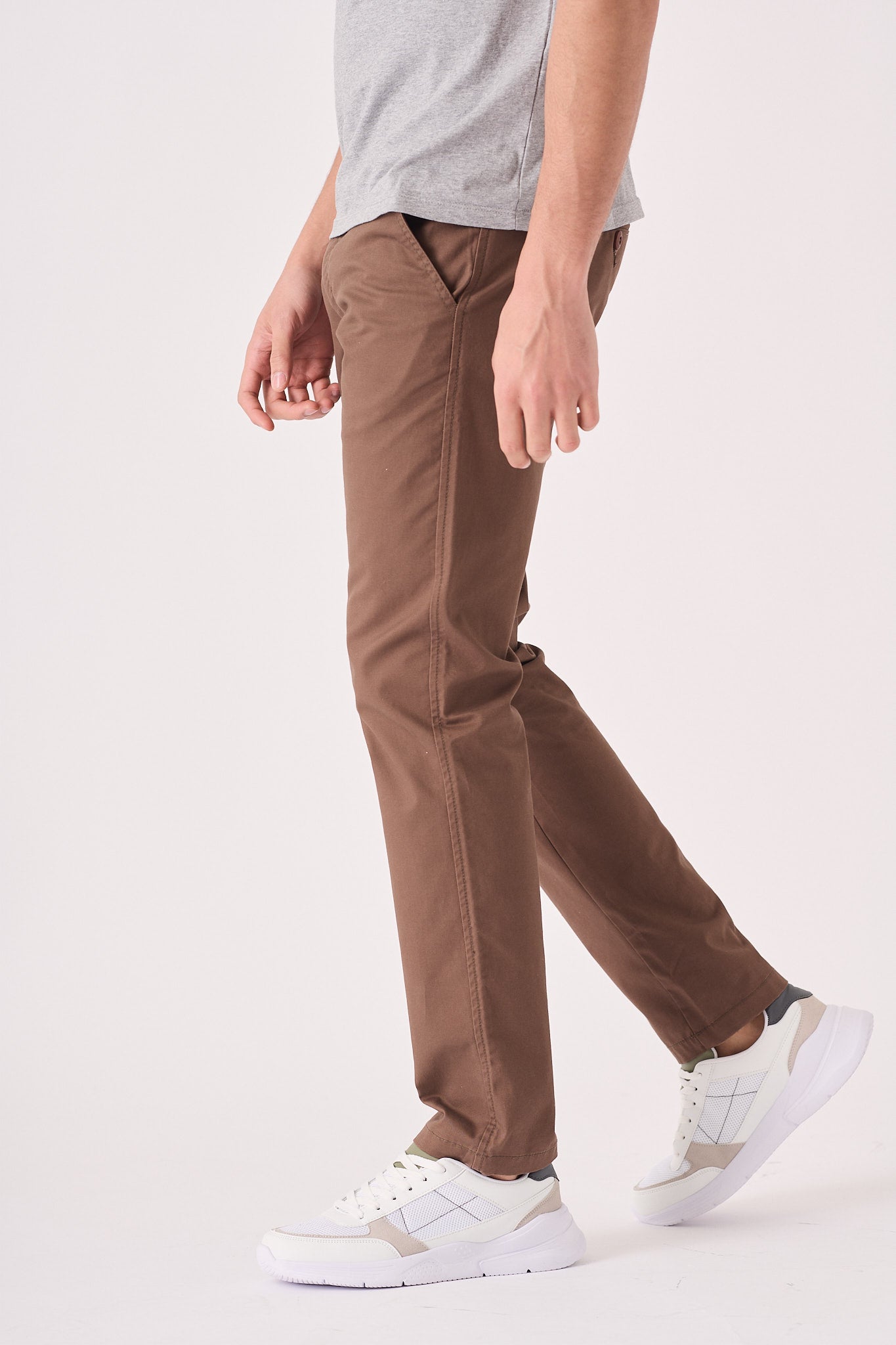 Side full length view of the stretch brown chino trousers.