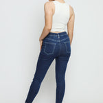 Full back view of the dark blue denim jeggings for women highlighting the flattering high-rise fit.