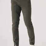 Detail shot of the front pocket area on dark olive green chinos.