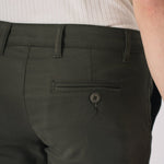 Front view of dark olive green chinos from the waist down.