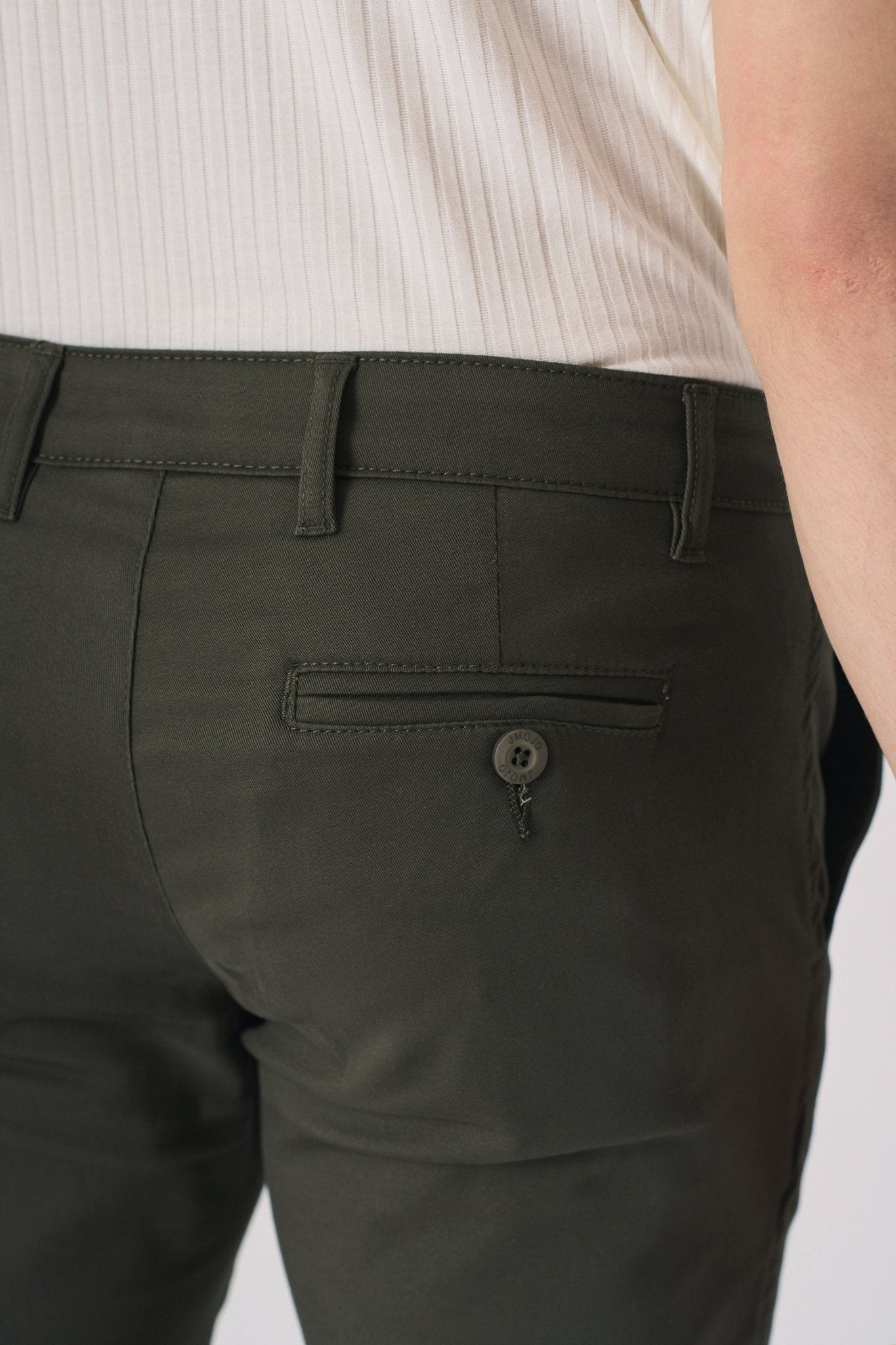 Front view of dark olive green chinos from the waist down.