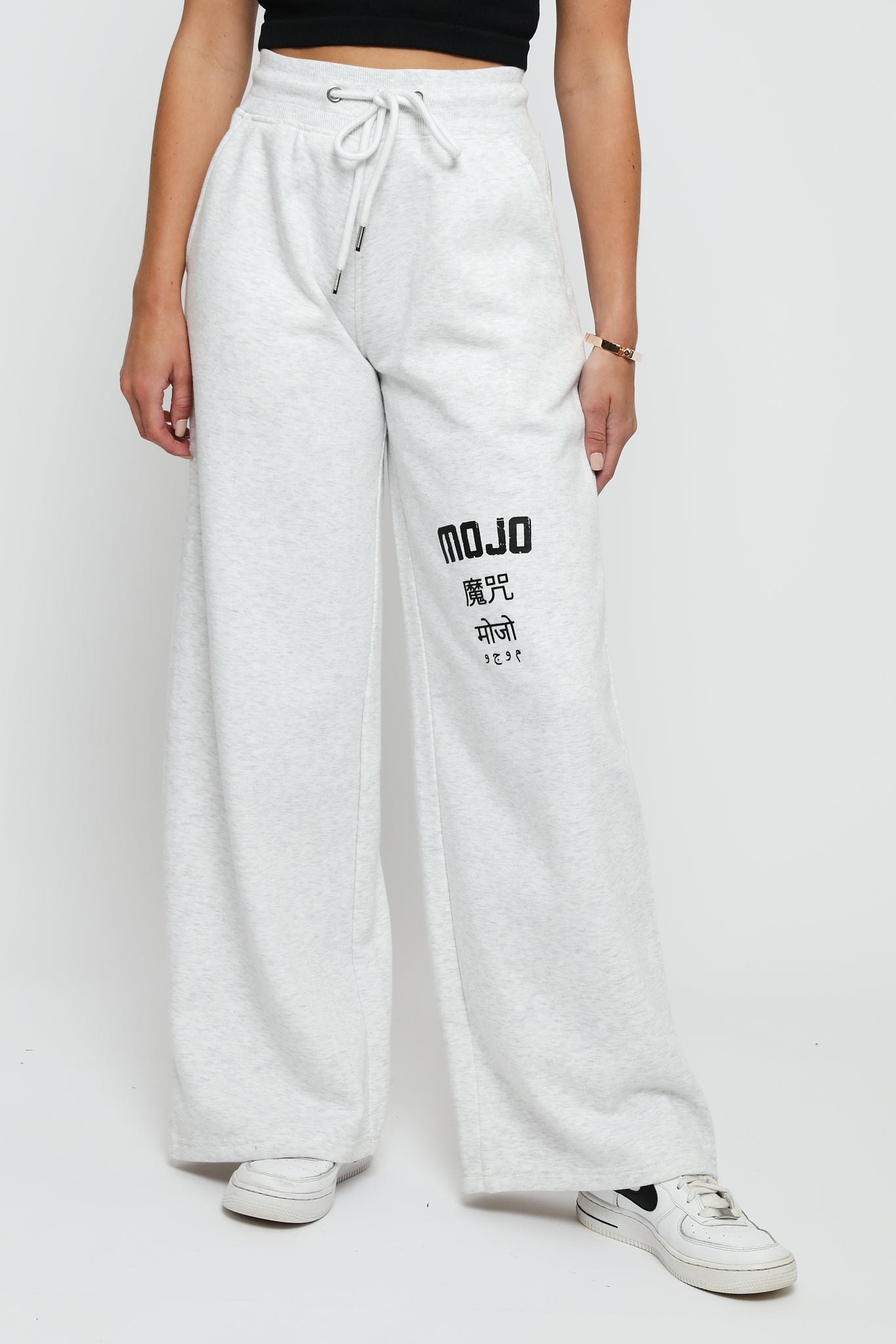 Front detail shot of the grey marl joggers womens showing the drawstring and logo.