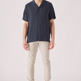 Full front view of a male model wearing cream chinos slim fit.