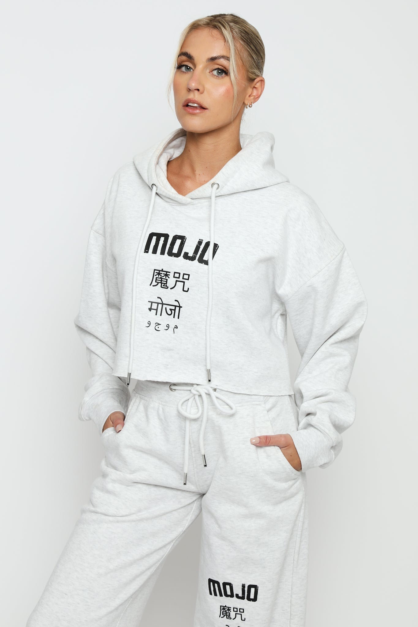 A woman wearing a stylish grey marl hoodie women's with logo detail.