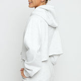 Side view of a woman wearing a grey marl hoodie women's.
