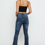 The back view of a woman wearing high waisted bootcut jeans showing the fitted silhouette.