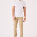 Full front view of a man wearing premium men's beige chinos slim fit.