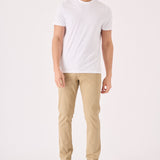 Full front view of a man wearing premium men's beige chinos slim fit.