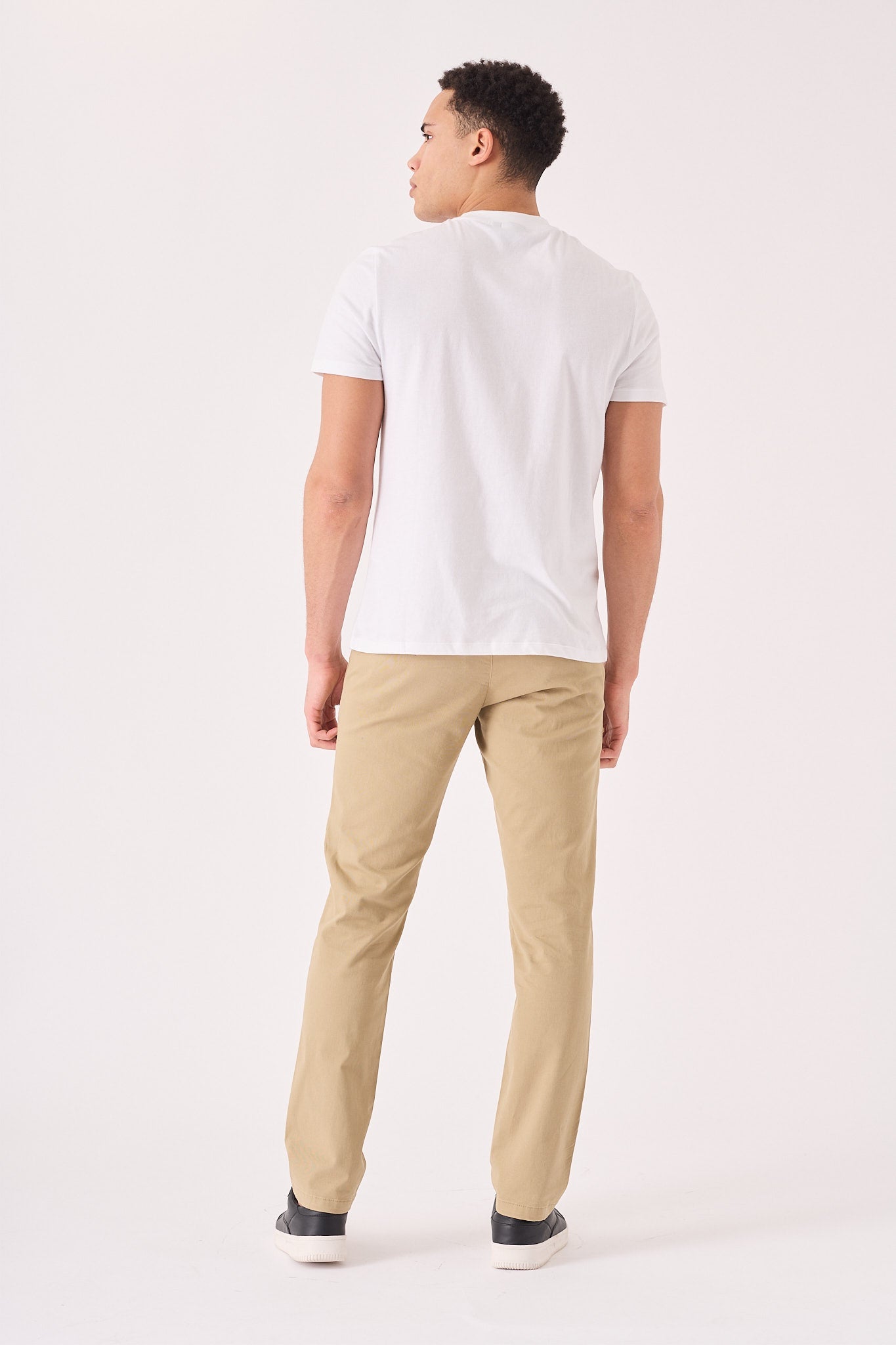 Back view showing the clean tailored cut of these men's beige chinos slim fit.
