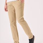 Side profile of a male model wearing men's beige chinos slim fit.