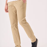 Side profile of a male model wearing men's beige chinos slim fit.