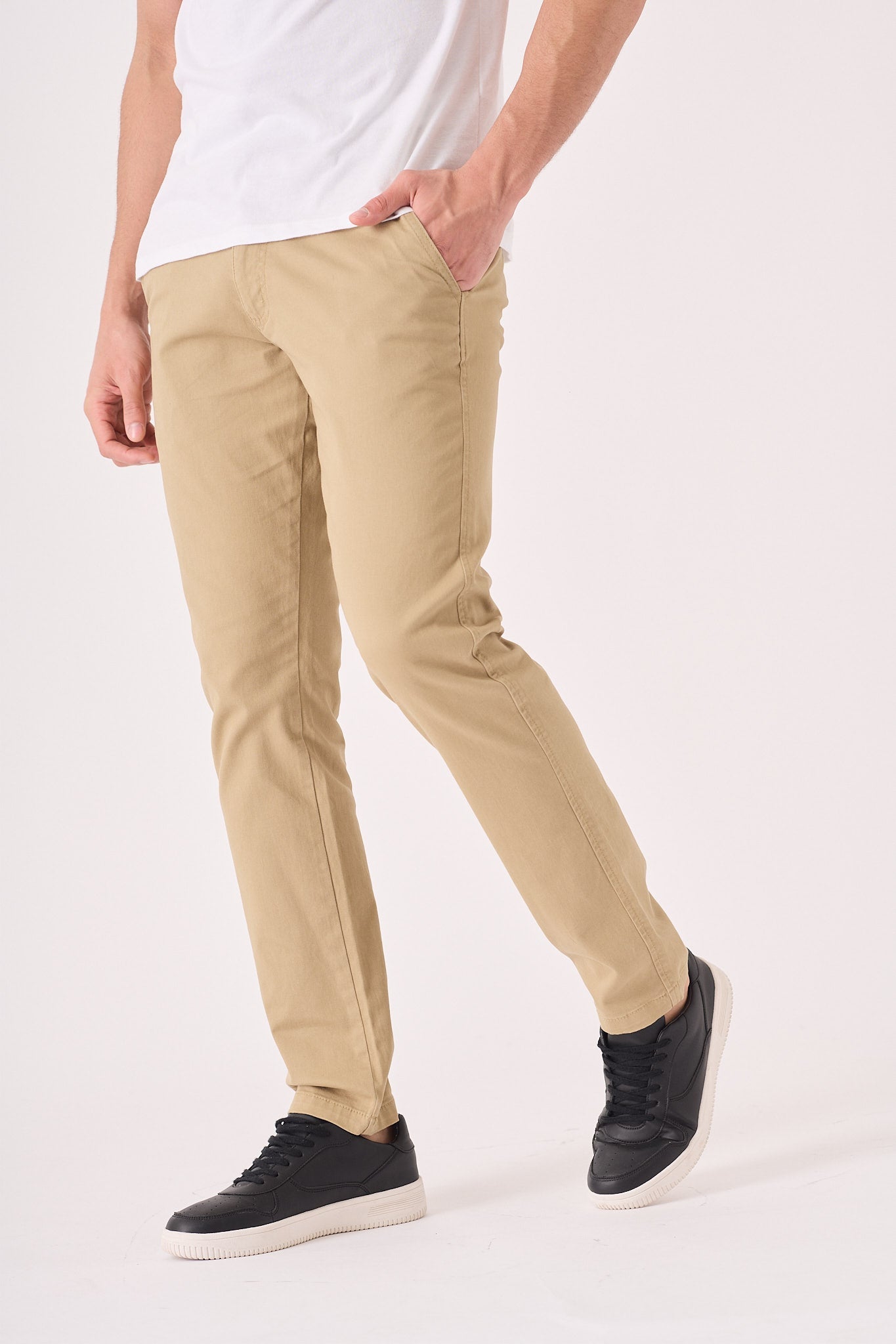 Side profile of a male model wearing men's beige chinos slim fit.