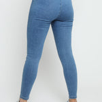 Back view of mid blue denim jeggings highlighting the elasticated waistband and pocket detail.