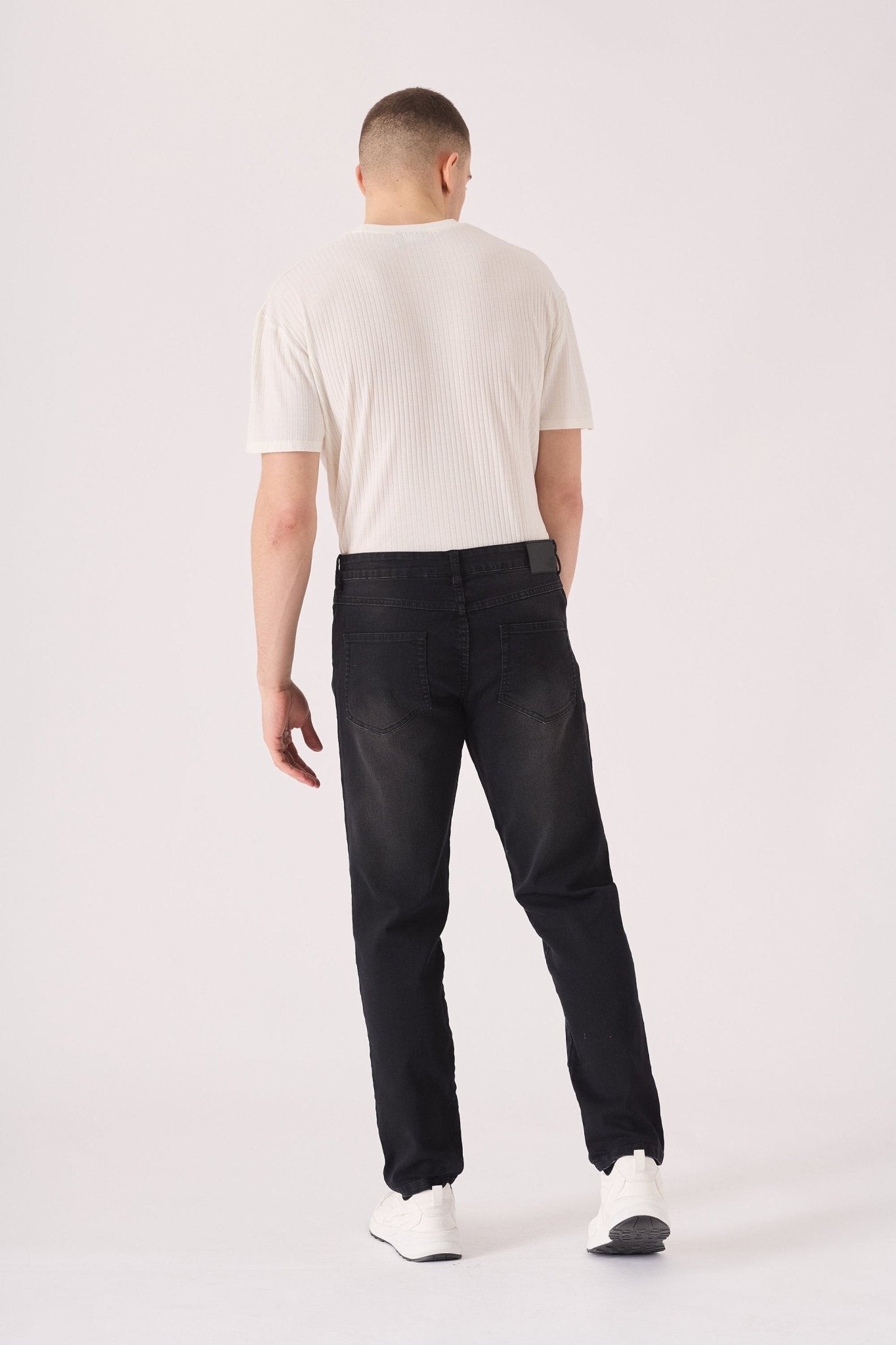 slim fit black washed jeans close up faded fabric detail