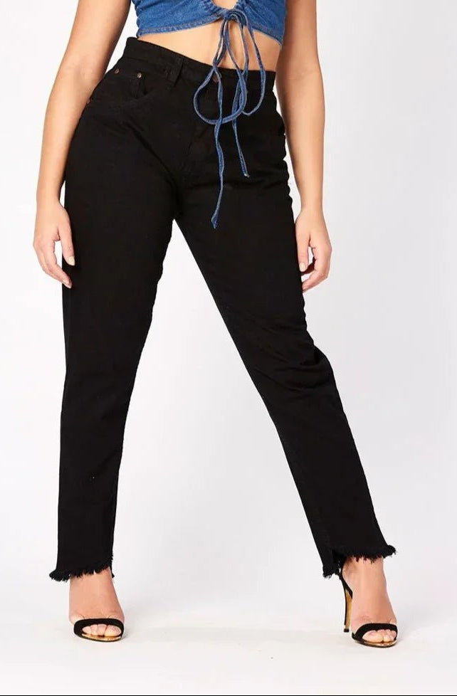 A model posing in womens high rise black frayed hem jeans featuring a stylish raw edge finish.